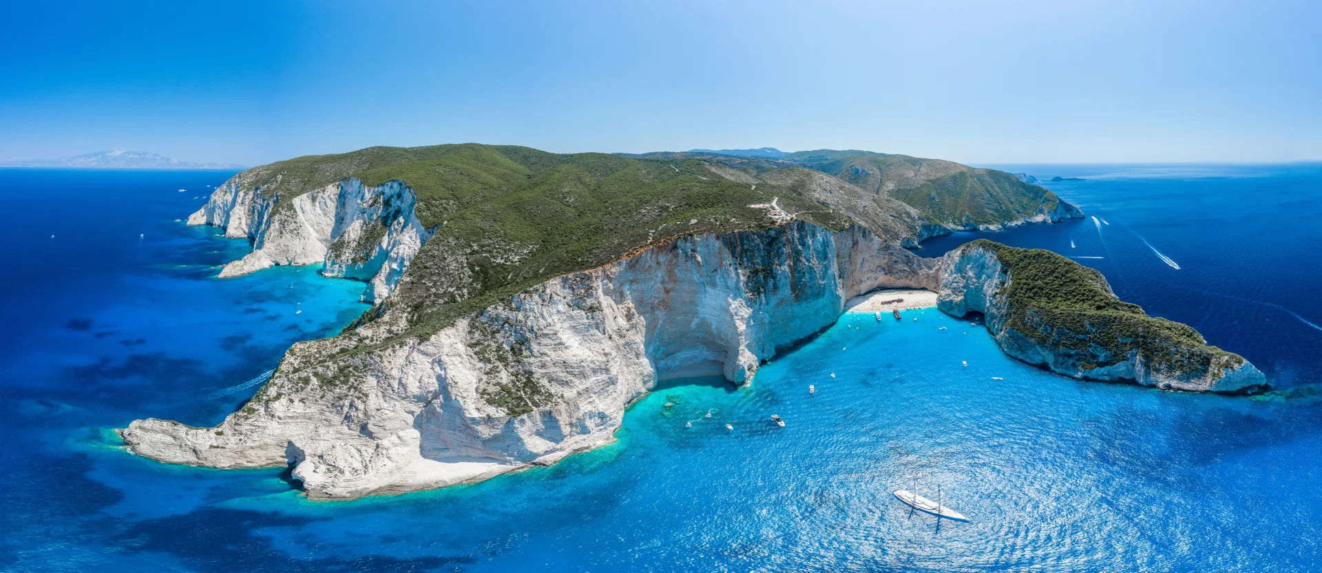 Spectacular aerial view of white limestone cliffs and turquoise waters on the Greek coast.
